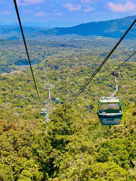 Kuranda Skyrail Rainforest Cableway gliding over lush forest canopy in Queensland, Australia.