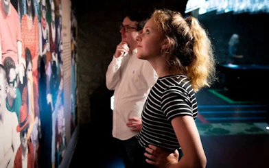 Visitors observing a colorful exhibit at the EPIC Museum.
