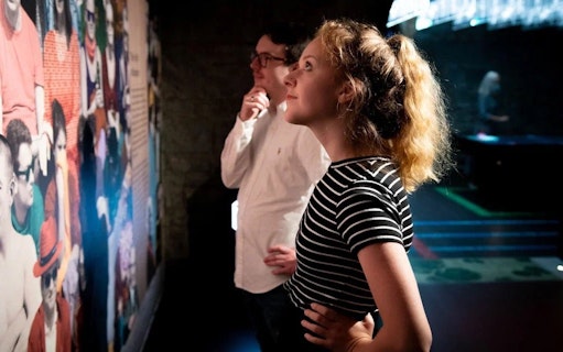 Visitors observing a colorful exhibit at the EPIC Museum.