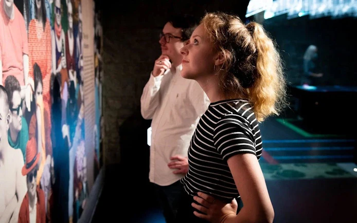 Visitors observing a colorful exhibit at the EPIC Museum.
