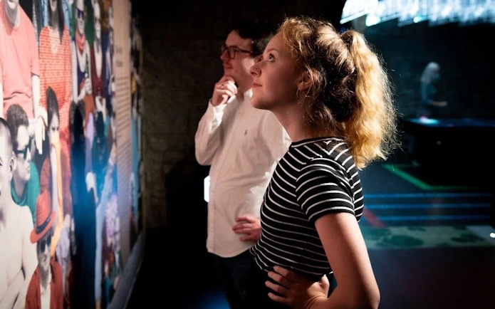 Visitors observing a colorful exhibit at the EPIC Museum.