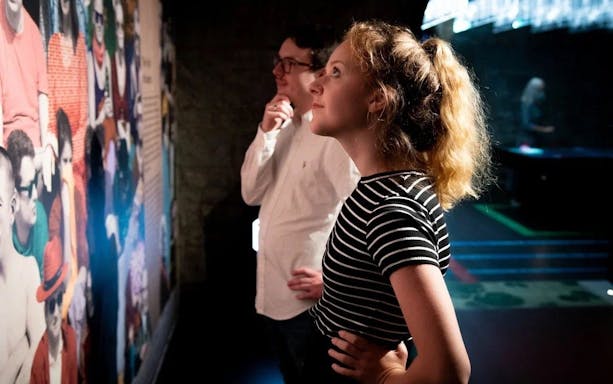 Visitors observing a colorful exhibit at the EPIC Museum.