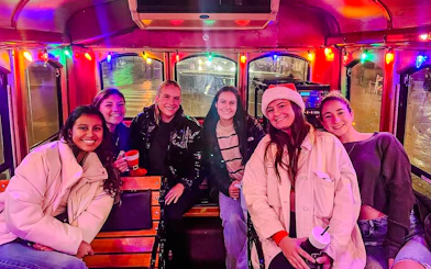 Group enjoying Philadelphia Holiday Lights Tour inside decorated trolley.