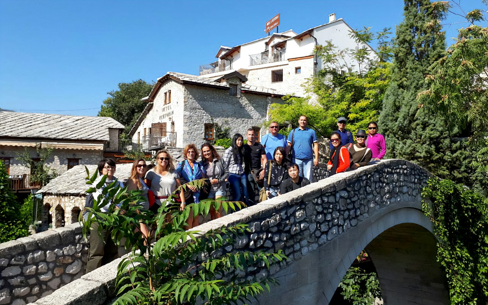 Tour group on a stone bridge in Mostar, Bosnia and Herzegovina.