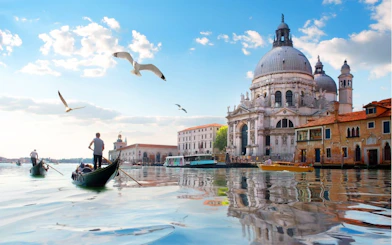 Gondolas on Venice canal near Santa Maria della Salute, part of Casanova's Venice exploration game.