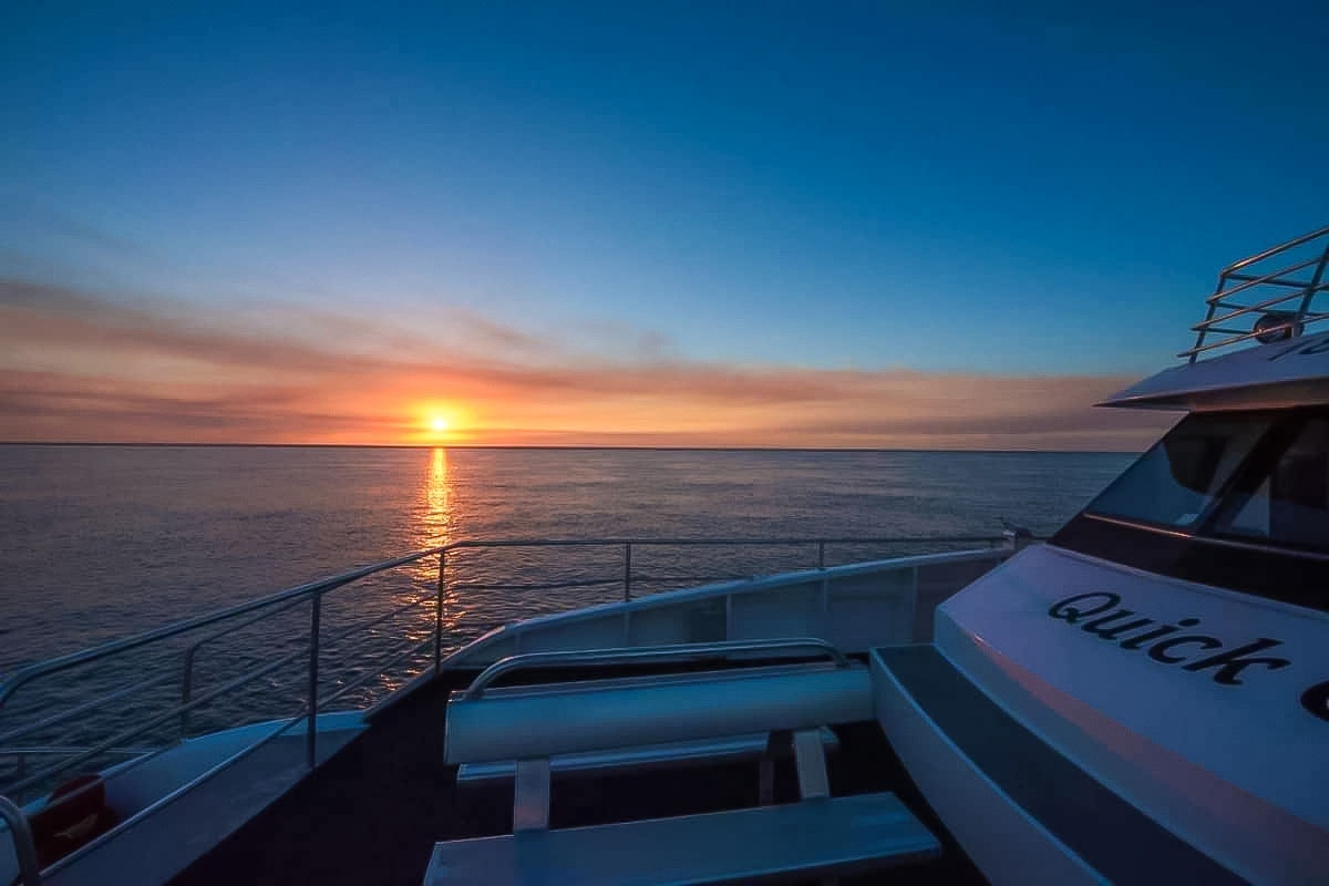 Sunset over the ocean from the deck of a "Quick Cat" tour boat in Hervey Bay.
