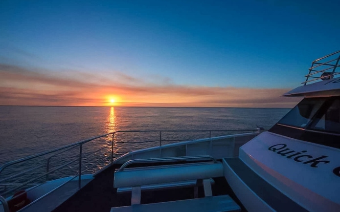 Sunset over the ocean from the deck of a "Quick Cat" tour boat in Hervey Bay.