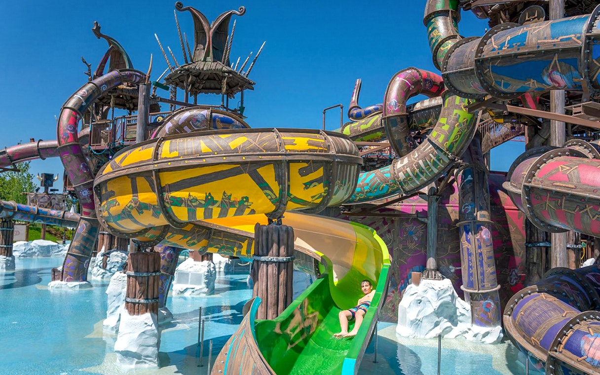 Water slides at Rulantica water park, Germany, with a child enjoying a ride.