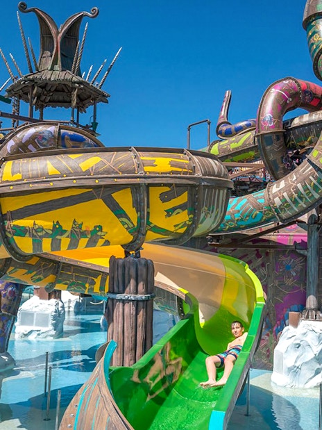 Water slides at Rulantica water park, Germany, with a child enjoying a ride.