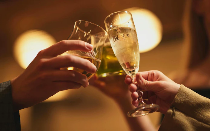 Toasting with drinks at DRUM TAO Theater Kyoto event.