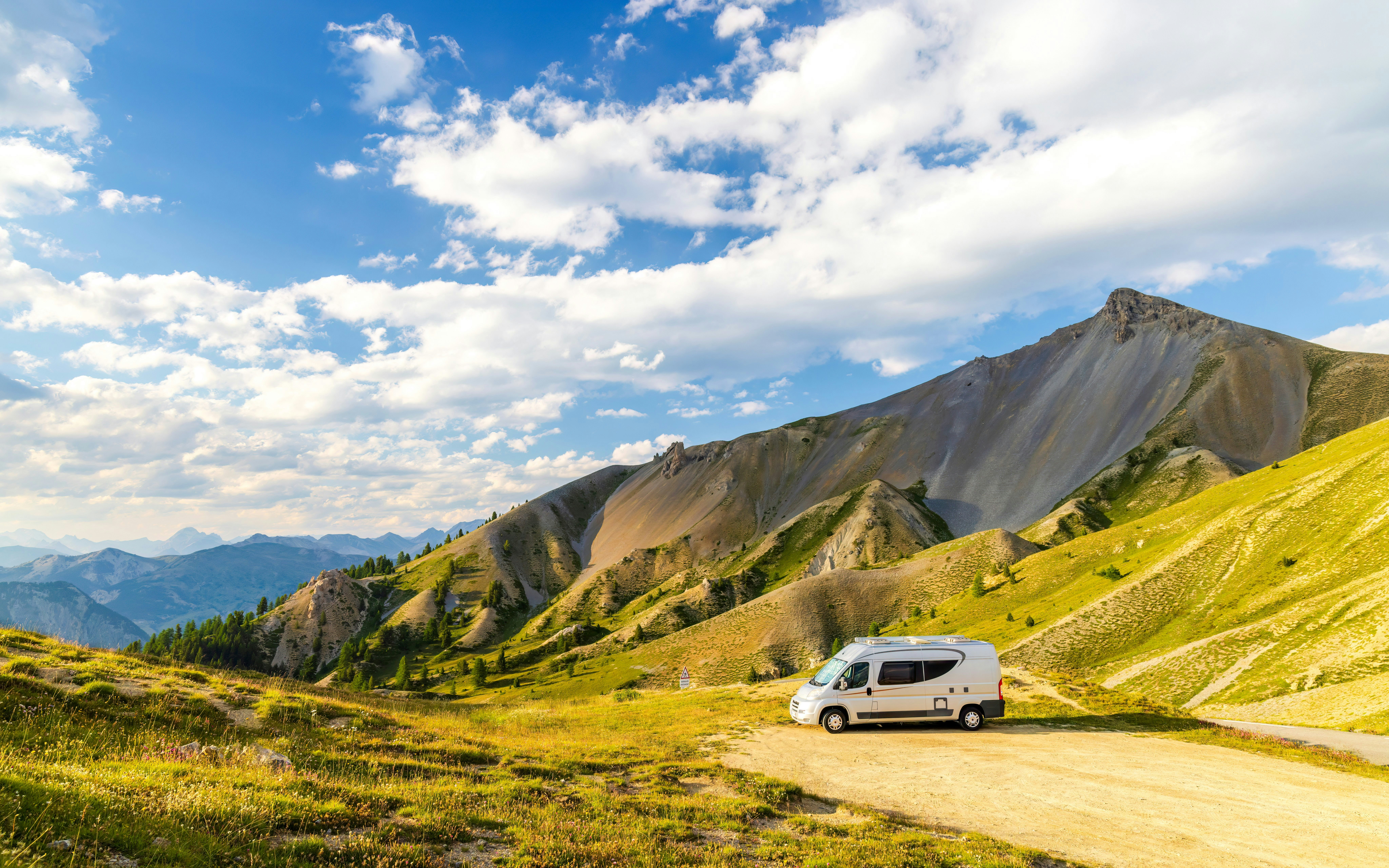 Camper van parked at Col de la Bonette with mountain views, Alpes-de-Haute-Provence, France.