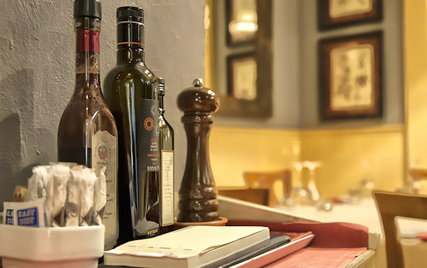 Olive oil and pepper on a table in a Florence restaurant for Opera Arias Concert & Pizza Dinner.
