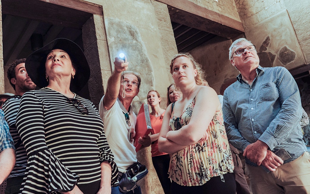 Group of tourists on a Herculaneum private guided tour inside ancient ruins.