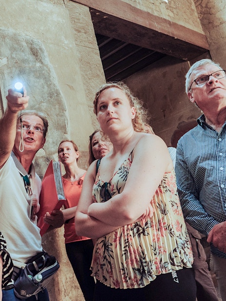 Group of tourists on a Herculaneum private guided tour inside ancient ruins.