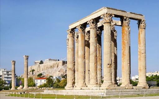 Temple of Olympian Zeus ruins with Acropolis in background, Athens, Greece.