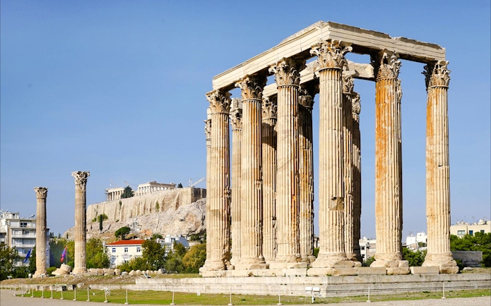 Temple of Olympian Zeus ruins with Acropolis in background, Athens, Greece.