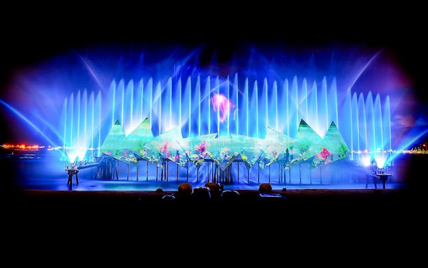 Wings of Time light and water show at Sentosa, Singapore, with vibrant projections.