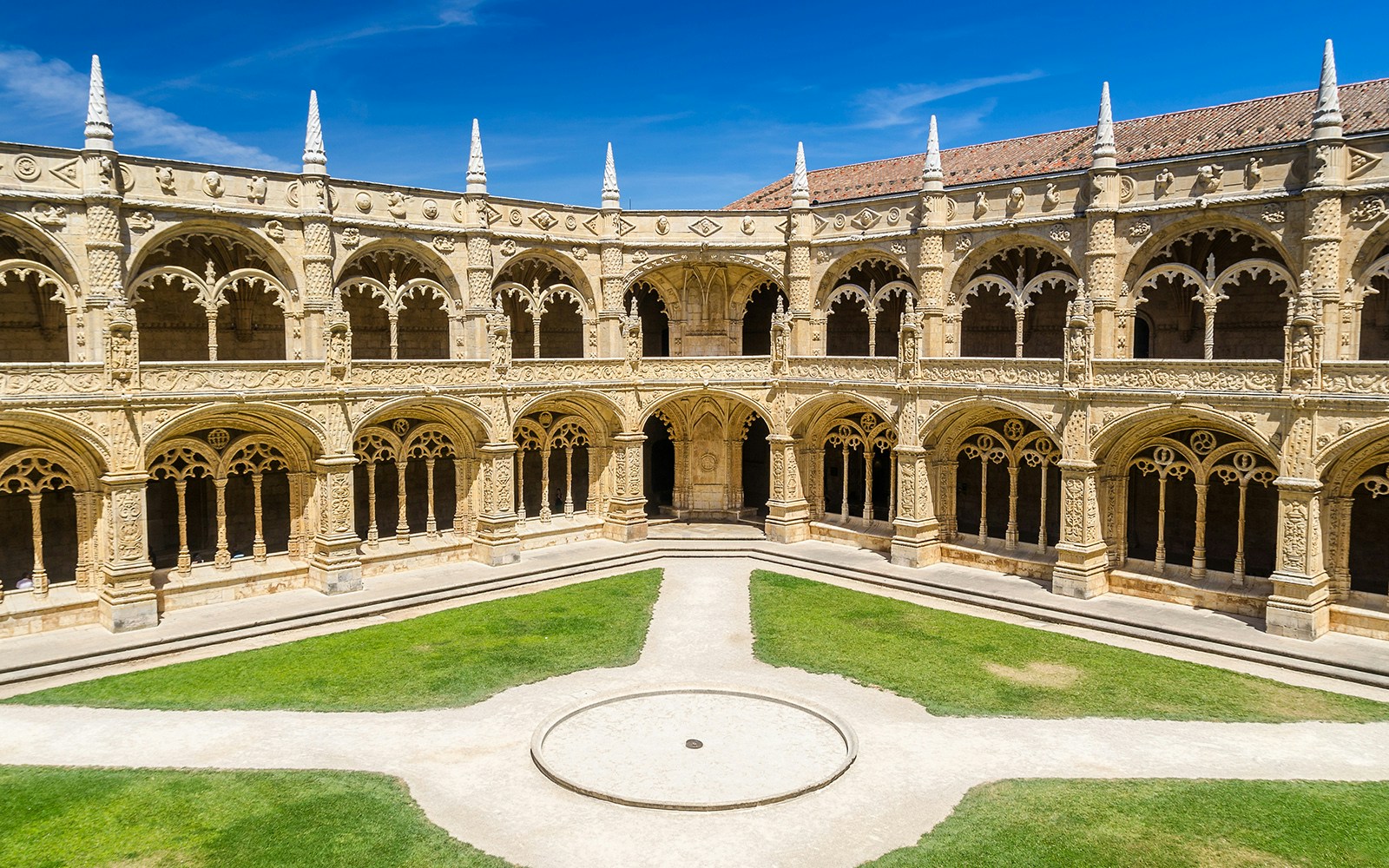 Cloister arches and ornate columns at Jeronimos Monastery, Lisbon, Portugal.