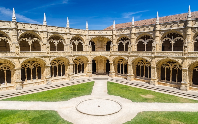 Cloister arches and ornate columns at Jeronimos Monastery, Lisbon, Portugal.