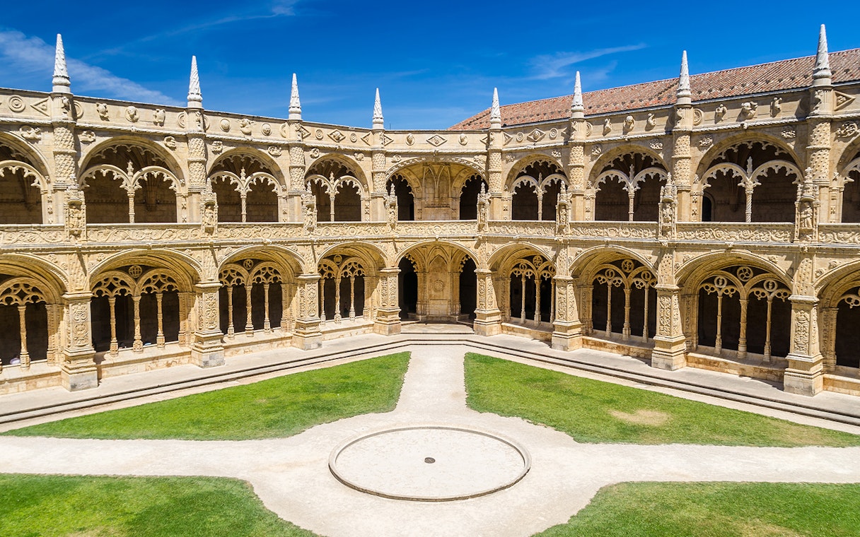 Cloister arches and ornate columns at Jeronimos Monastery, Lisbon, Portugal.