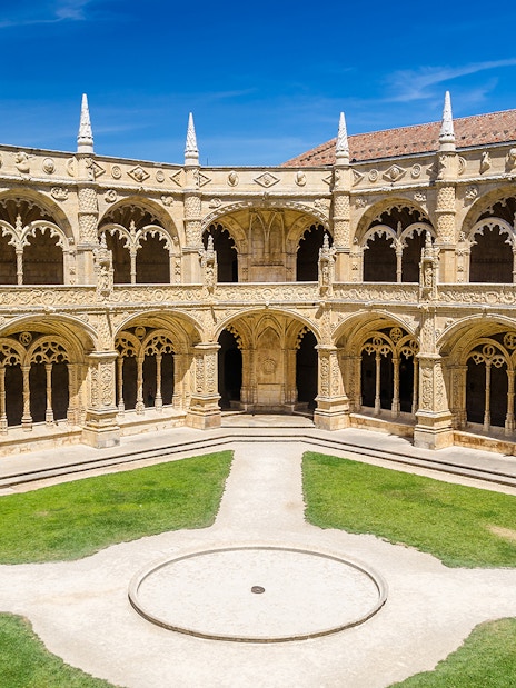 Cloister arches and ornate columns at Jeronimos Monastery, Lisbon, Portugal.