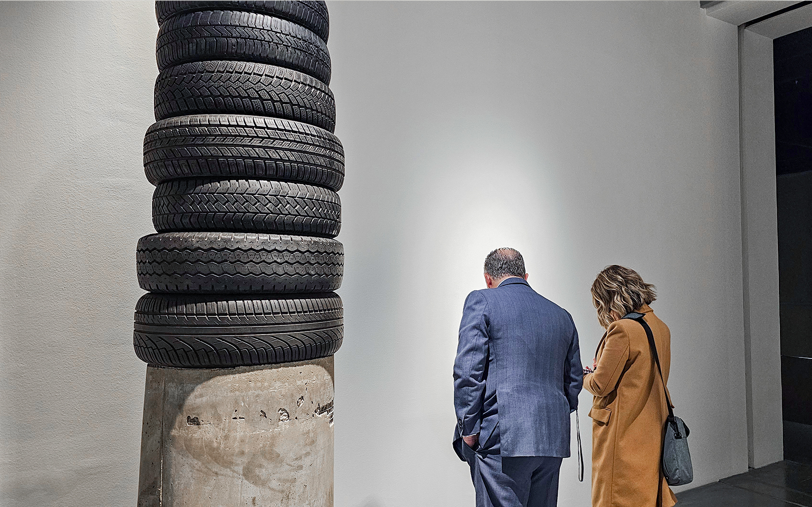 Visitors observing tire sculpture at Picasso's Birthplace Museum.