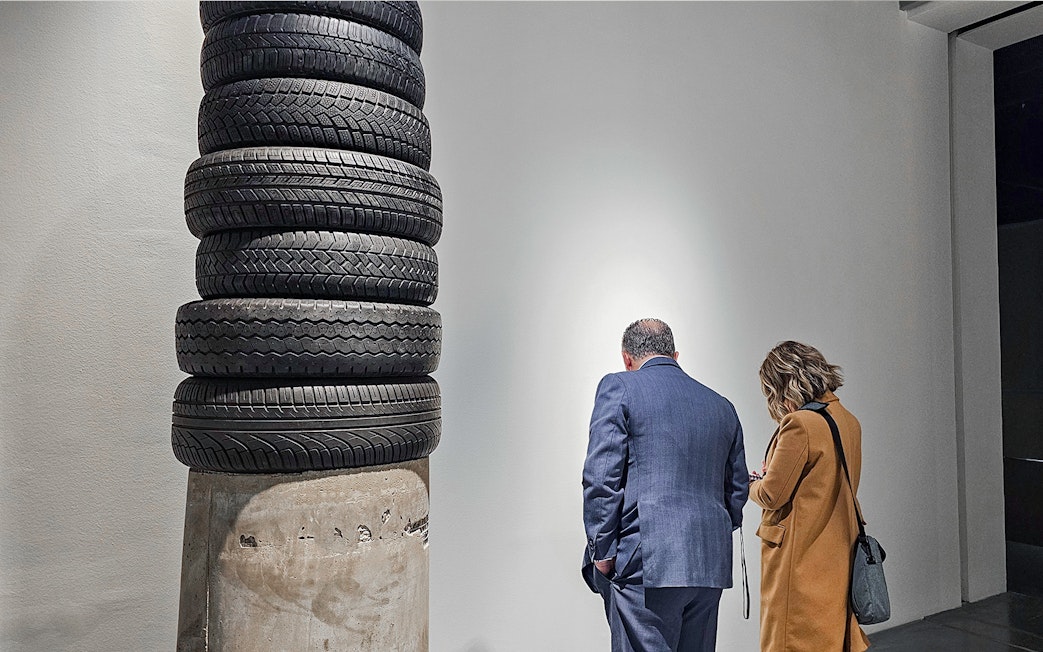 Visitors observing tire sculpture at Picasso's Birthplace Museum.