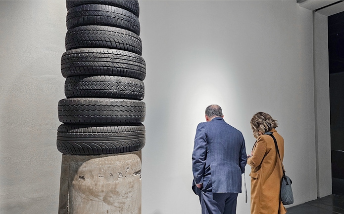 Visitors observing tire sculpture at Picasso's Birthplace Museum.