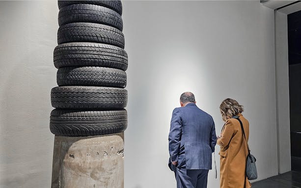 Visitors observing tire sculpture at Picasso's Birthplace Museum.