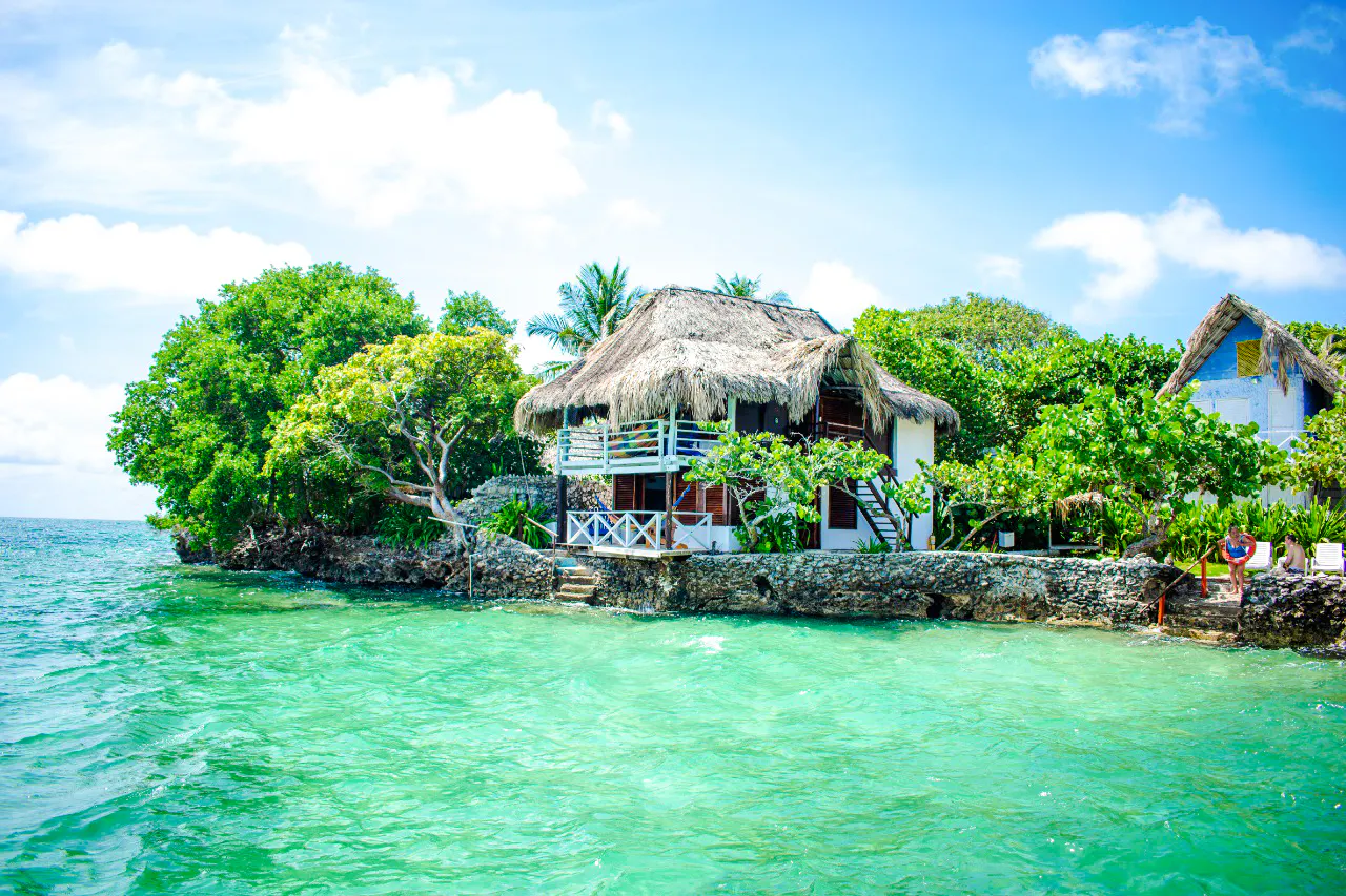 Thatched-roof hut by the turquoise waters of Rosario Islands, Cartagena.