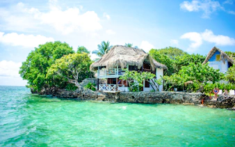 Thatched-roof hut by the turquoise waters of Rosario Islands, Cartagena.