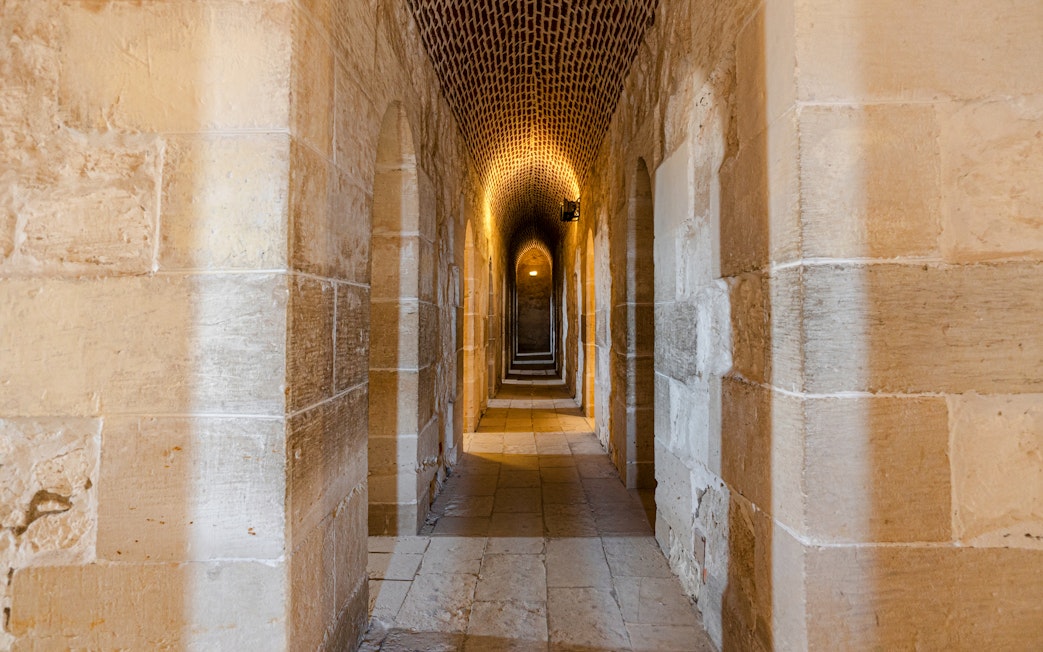 Interior view of Fort of Qaitbay, Alexandria showcasing ancient stone walls and arched passageways.