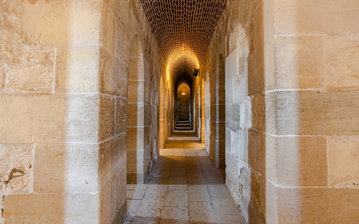 Interior view of Fort of Qaitbay, Alexandria showcasing ancient stone walls and arched passageways.