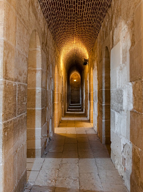 Interior view of Fort of Qaitbay, Alexandria showcasing ancient stone walls and arched passageways.