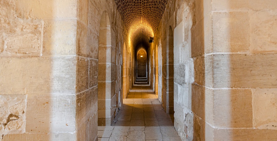 Interior view of Fort of Qaitbay, Alexandria showcasing ancient stone walls and arched passageways.