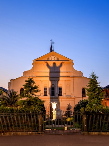St. Louis Cathedral facade with shadow of Jesus statue, French Quarter, New Orleans.