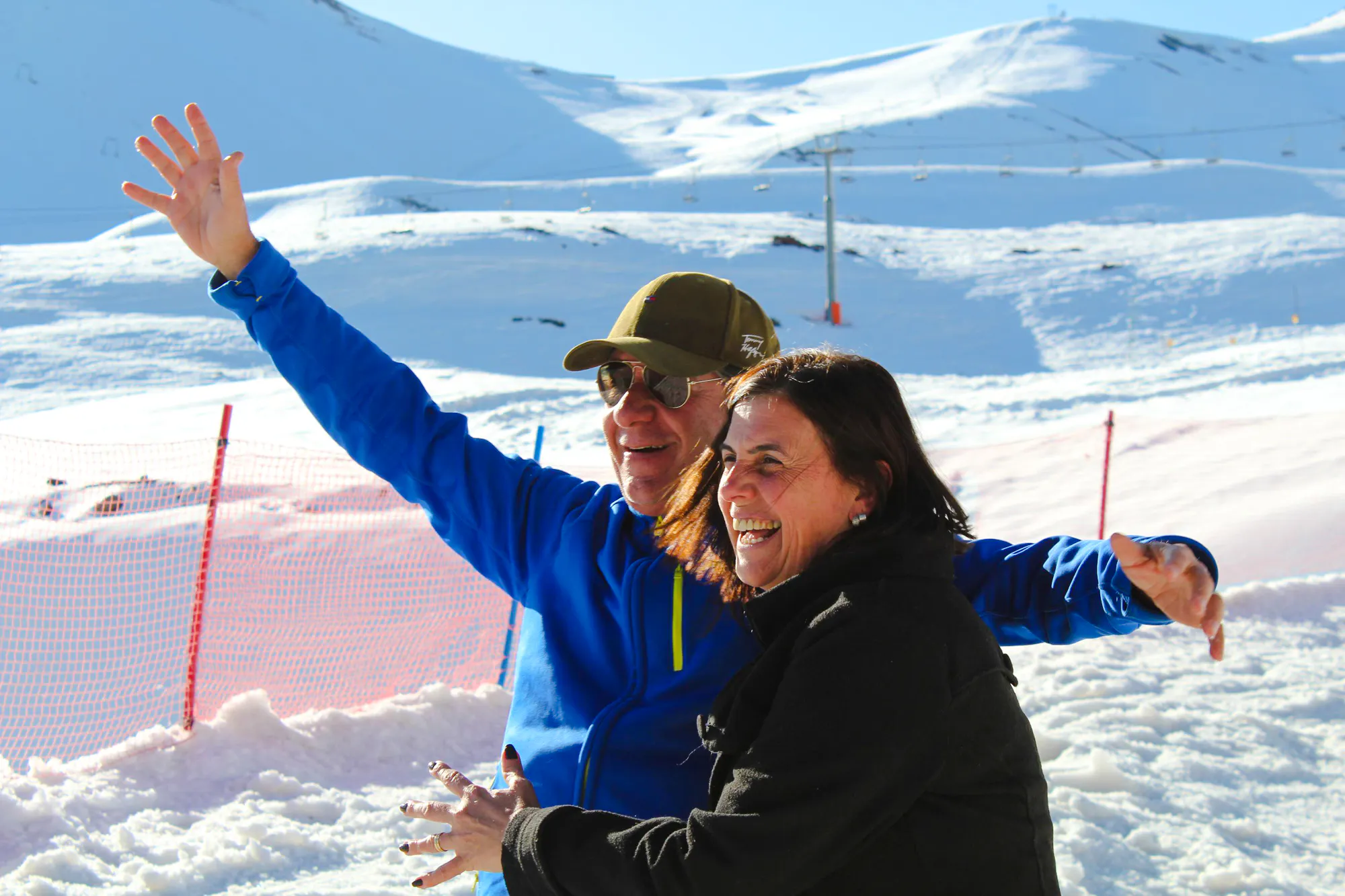 Two people enjoying the snowy landscape at Valle Nevado, Santiago.