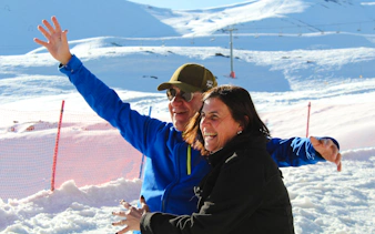 Two people enjoying the snowy landscape at Valle Nevado, Santiago.