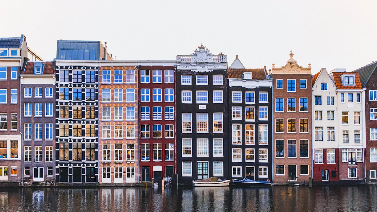 Canal houses in the Jordaan district, Amsterdam, reflecting in the water.