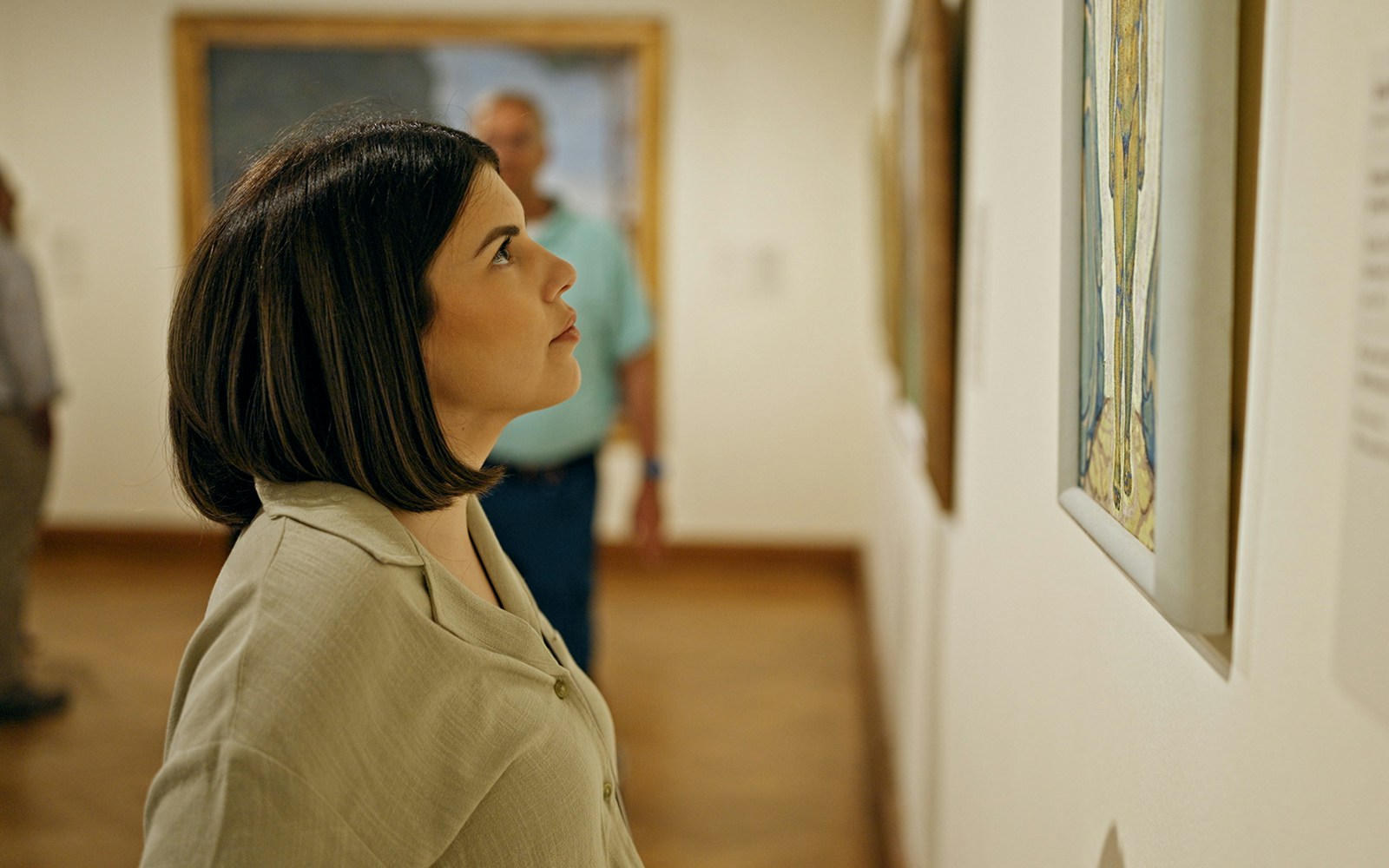 A couple holding artwork from Frist Art Museum