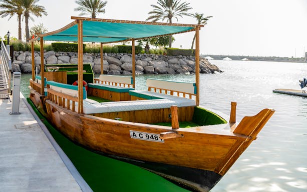 Traditional wooden boat docked in Abu Dhabi for Gulf Highlights Cruise.