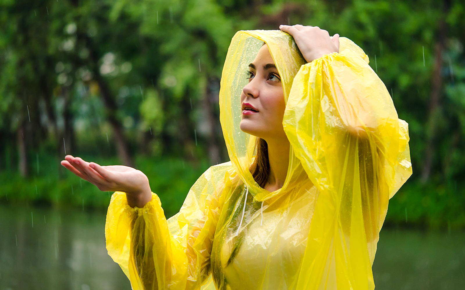 A woman enjoying the rain in a poncho