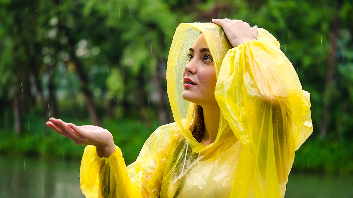A woman enjoying the rain in a poncho