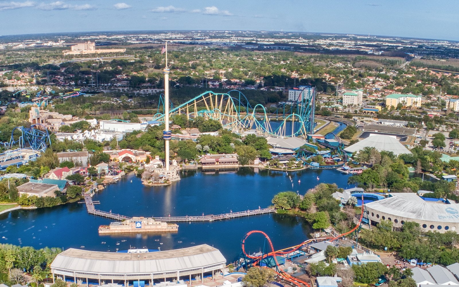 Aerial view of SeaWorld Amusement Park with roller coasters and central lake in Orlando, Florida.