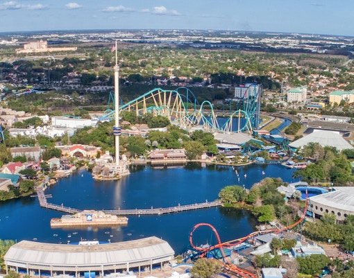 Aerial view of SeaWorld Amusement Park with roller coasters and central lake in Orlando, Florida.