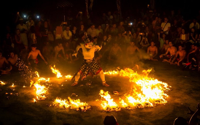 Performer in traditional costume during Kecak and Fire Dance Show at Melasti Beach.