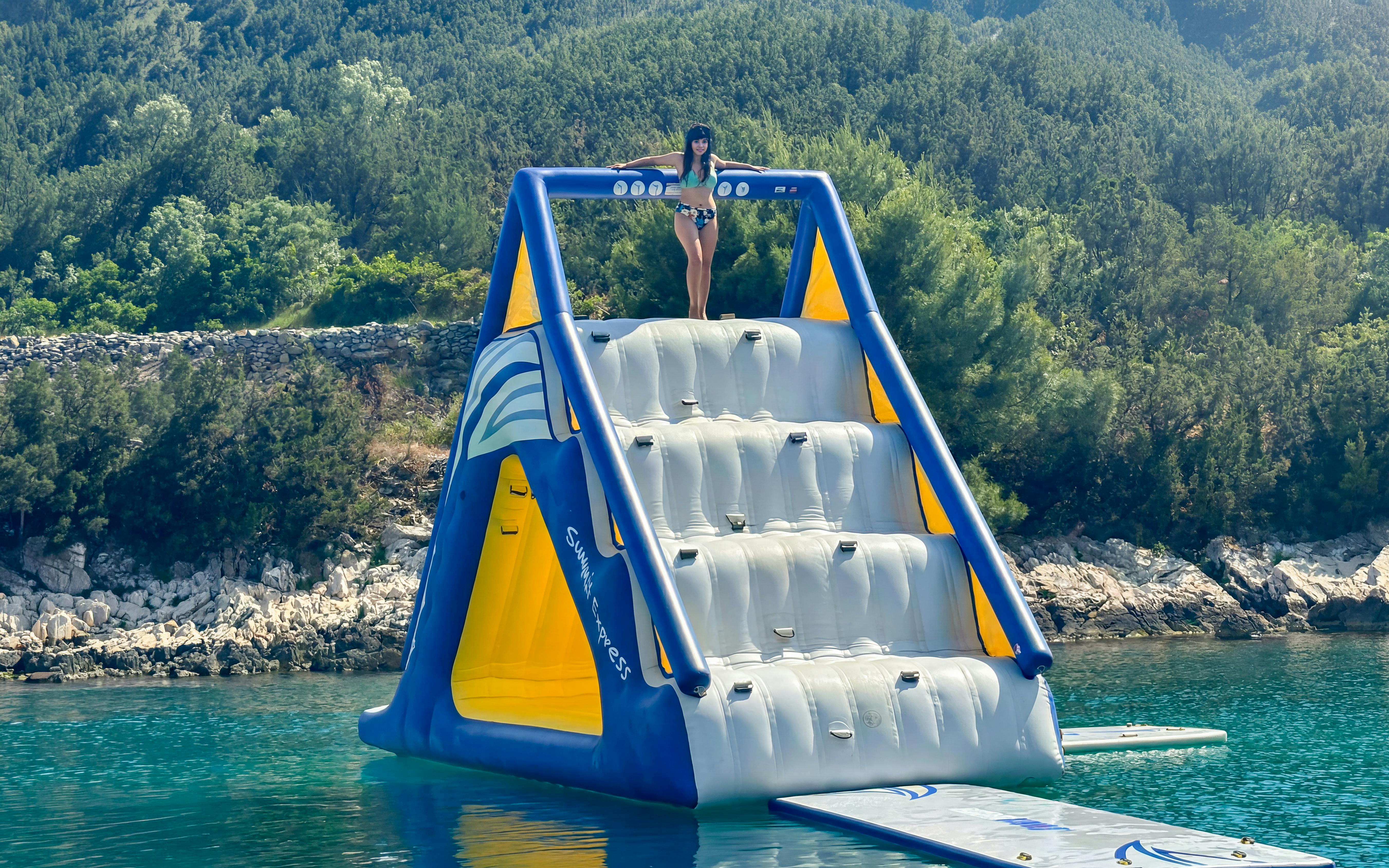 Inflatable water slide at beach resort near underwater museum.