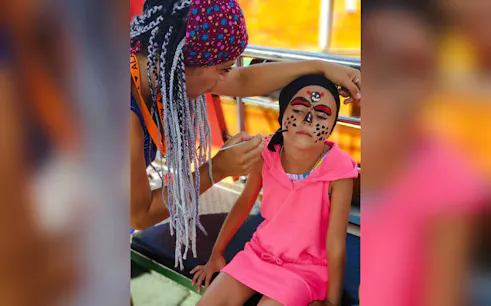 Child getting pirate face paint on Antalya Kundu boat tour.