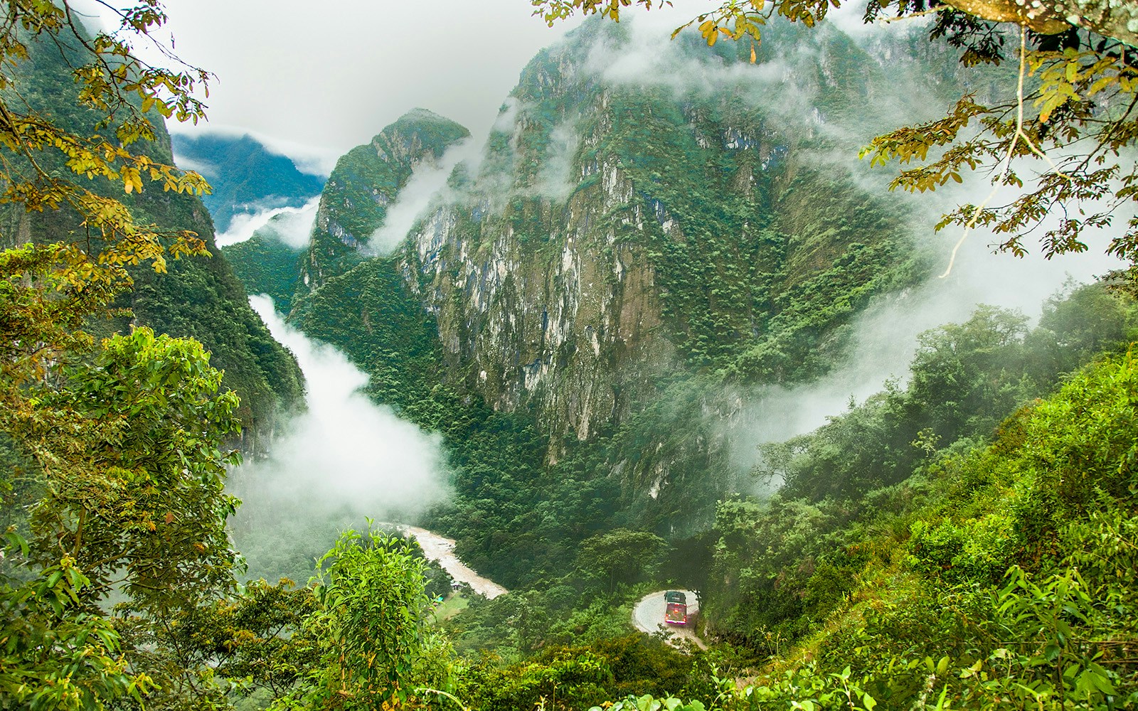 Mountainous landscape with mist and a winding road in Machu Picchu, Peru.
