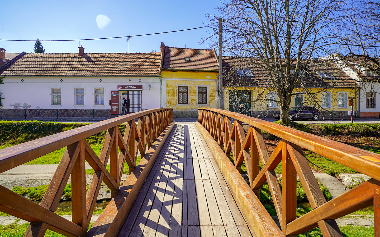 Wooden bridge leading to colorful houses in Szentendre village, Hungary.